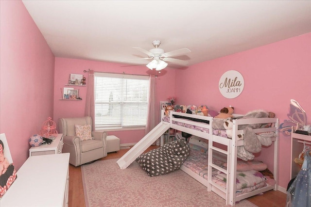 bedroom featuring baseboards and wood finished floors