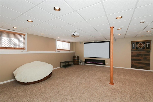 carpeted cinema room with a paneled ceiling, baseboards, and recessed lighting