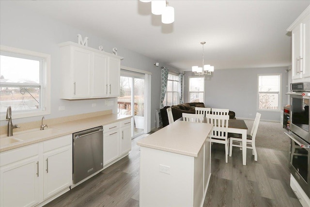 kitchen featuring dark wood-style floors, white cabinetry, stainless steel appliances, and a sink