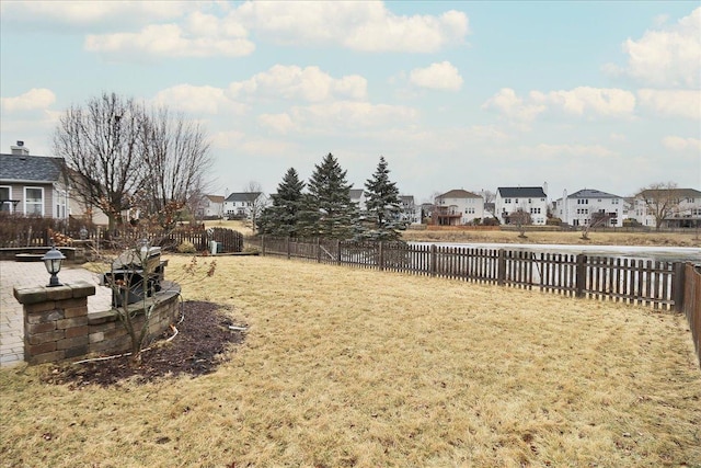 view of yard with a residential view and a fenced backyard