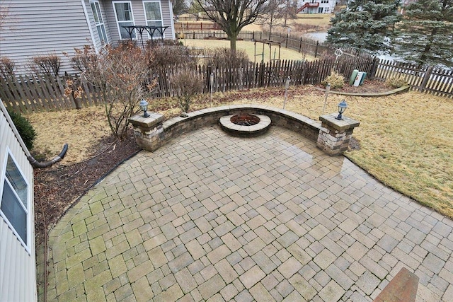 view of patio / terrace with a fenced backyard and a fire pit