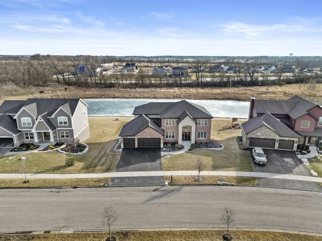 bird's eye view with a residential view and a water view