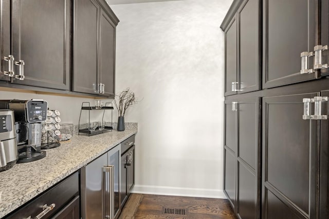 bar with visible vents, wine cooler, baseboards, and dark wood finished floors