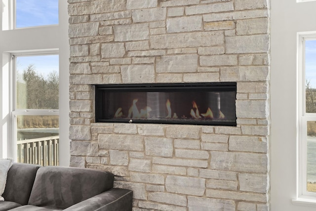 details featuring a glass covered fireplace