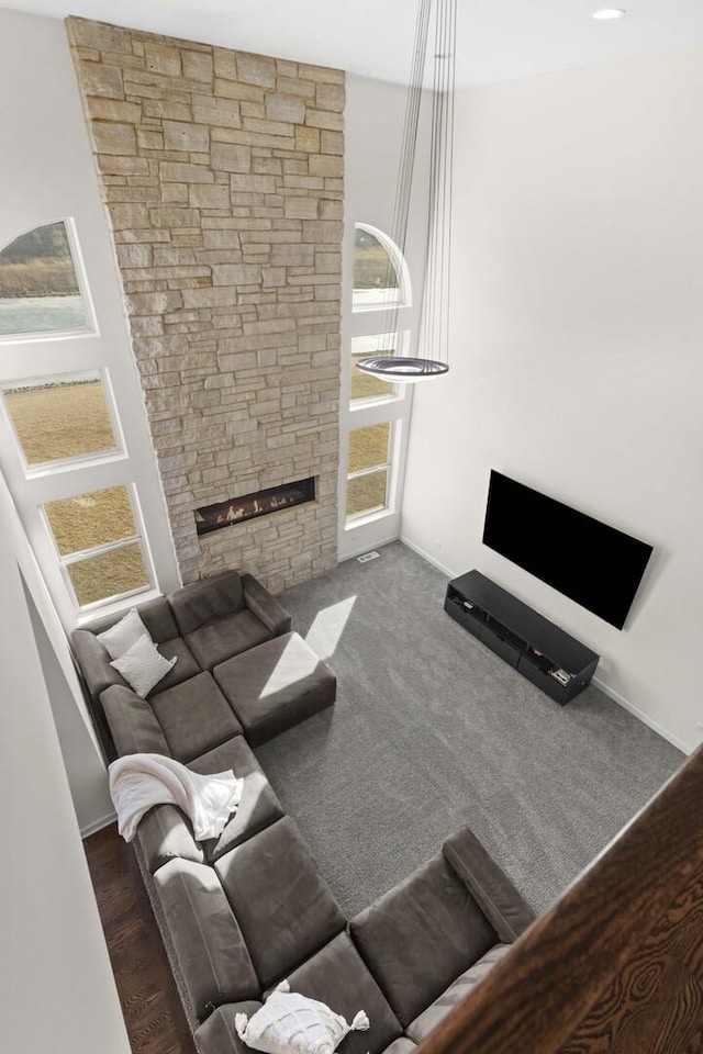 living room with a stone fireplace