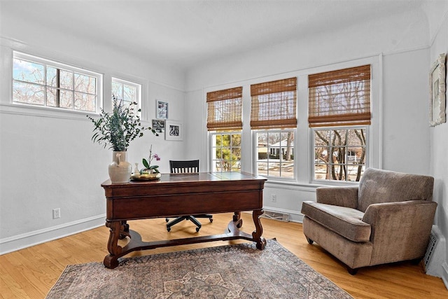 office space featuring light wood-style floors and baseboards