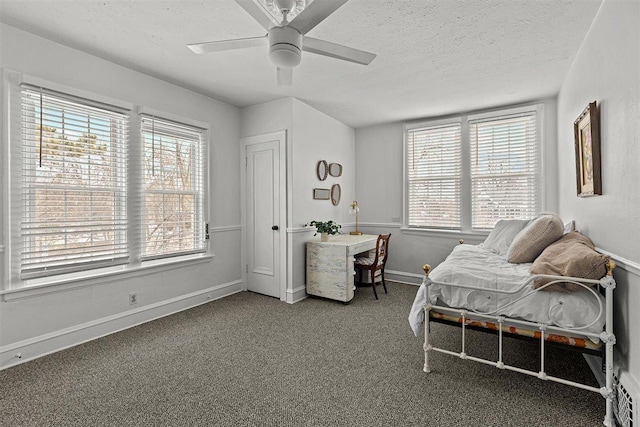 living area featuring ceiling fan, a textured ceiling, baseboards, and carpet flooring