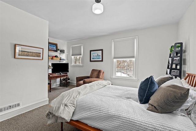 bedroom featuring dark colored carpet, visible vents, and baseboards