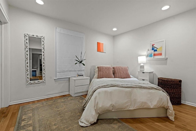 bedroom with wood finished floors and recessed lighting