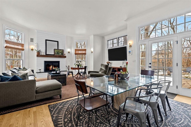 dining room with a glass covered fireplace and light wood finished floors