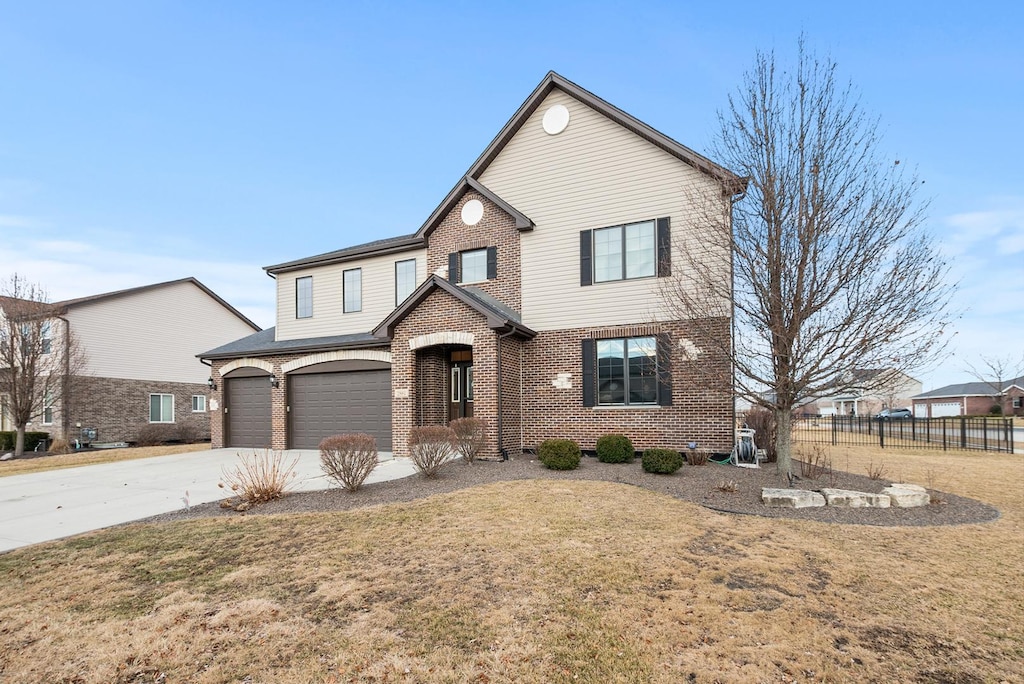 2884 Brett Dr, New Lenox, IL 60451 - view of front facade with an attached garage, brick siding, fence, concrete driveway, and a front lawn