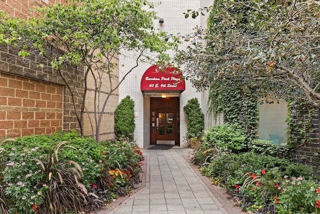 view of exterior entry with brick siding