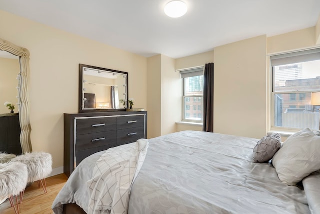 bedroom with light wood-style flooring and baseboards