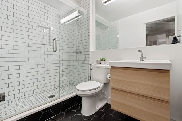 full bathroom with toilet, a shower stall, vanity, and tile patterned floors