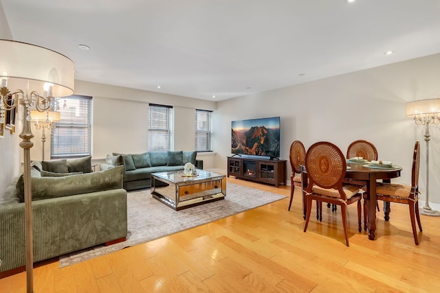 living room with light wood finished floors and recessed lighting