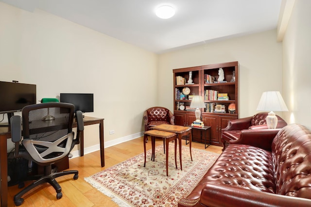 office featuring light wood-type flooring and baseboards