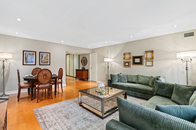 living area featuring light wood-style flooring, visible vents, and recessed lighting