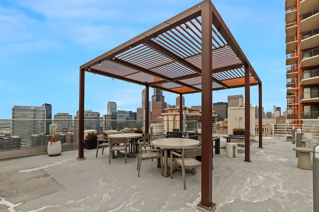 view of patio with a view of city, outdoor dining area, and a pergola