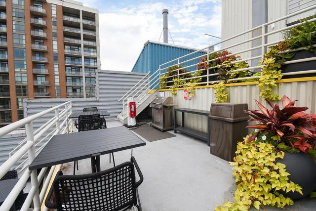 exterior space featuring stairs, area for grilling, and outdoor dining space