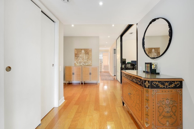 corridor with light wood finished floors and recessed lighting