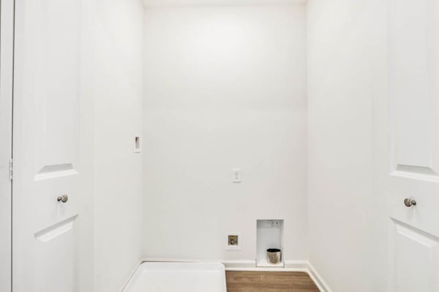 laundry area with hookup for a washing machine, laundry area, baseboards, and wood finished floors