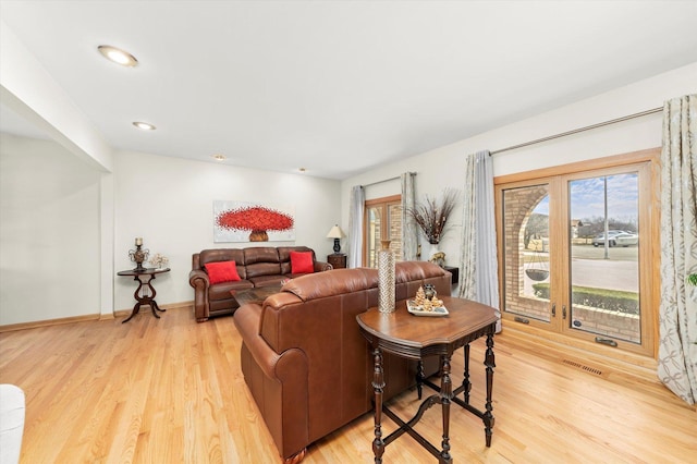 living room featuring visible vents, recessed lighting, light wood-style flooring, and baseboards