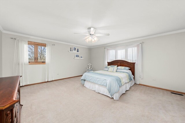 bedroom with ornamental molding, light carpet, baseboards, and multiple windows