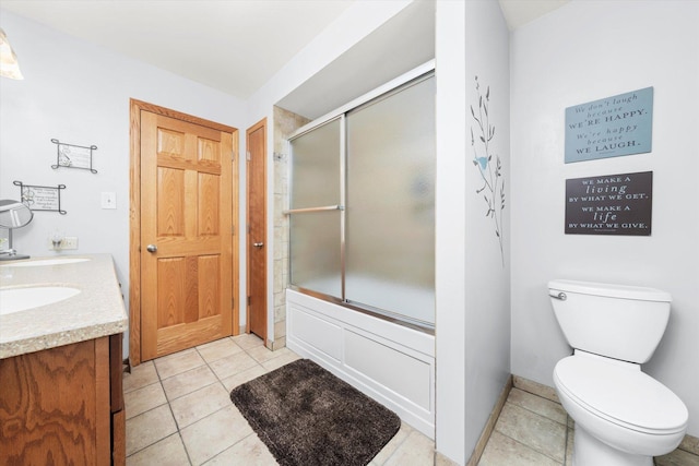 full bath with double vanity, combined bath / shower with glass door, toilet, and tile patterned floors