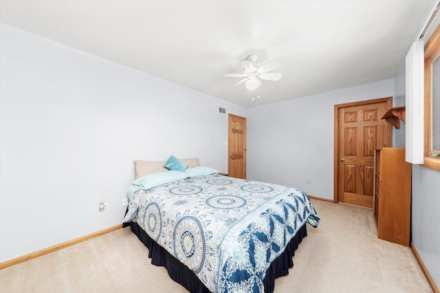 bedroom featuring light carpet, ceiling fan, visible vents, and baseboards