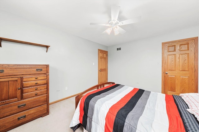 bedroom featuring light carpet, ceiling fan, visible vents, and baseboards