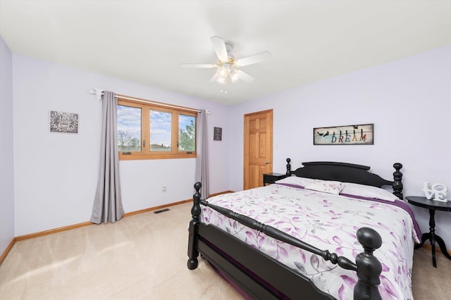 bedroom with visible vents, ceiling fan, light carpet, and baseboards