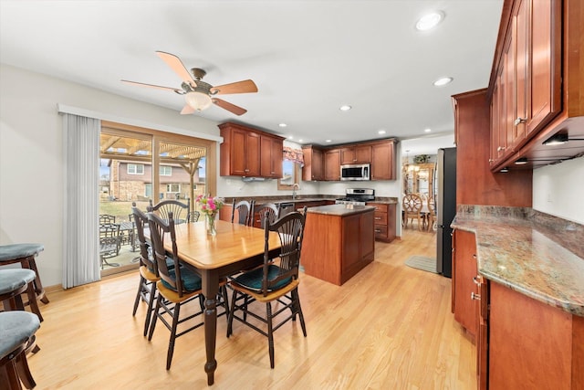 dining room featuring a ceiling fan, recessed lighting, and light wood finished floors