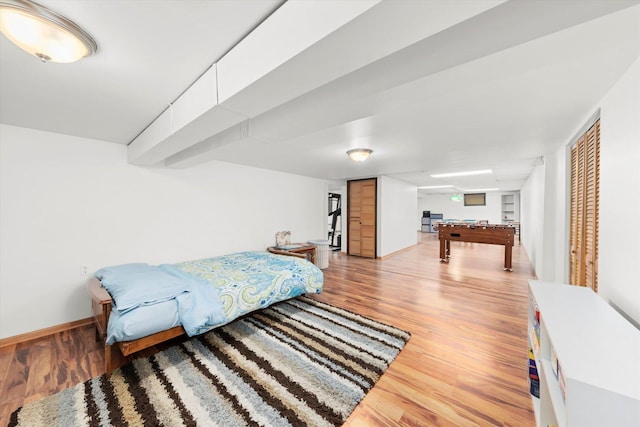 bedroom featuring baseboards, pool table, a closet, and light wood-style floors