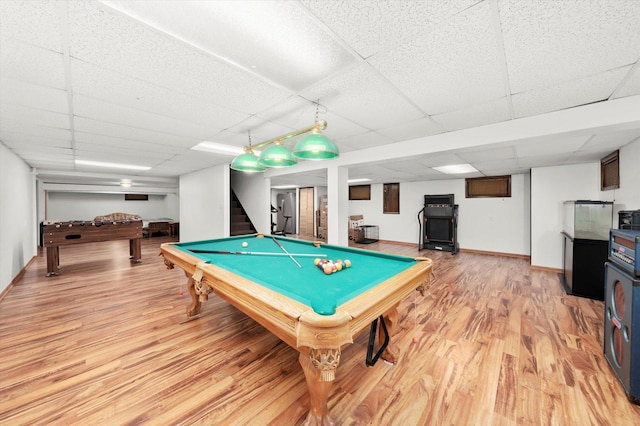 game room featuring pool table, light wood-type flooring, a paneled ceiling, and baseboards