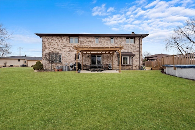 back of house with brick siding, a lawn, a fenced in pool, a pergola, and a patio area