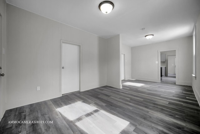 spare room with dark wood-type flooring