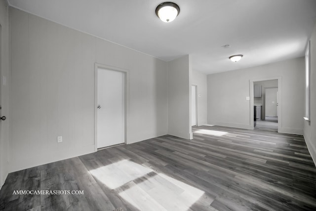 spare room featuring dark wood-style flooring