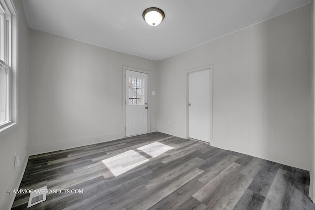 empty room with wood finished floors and visible vents