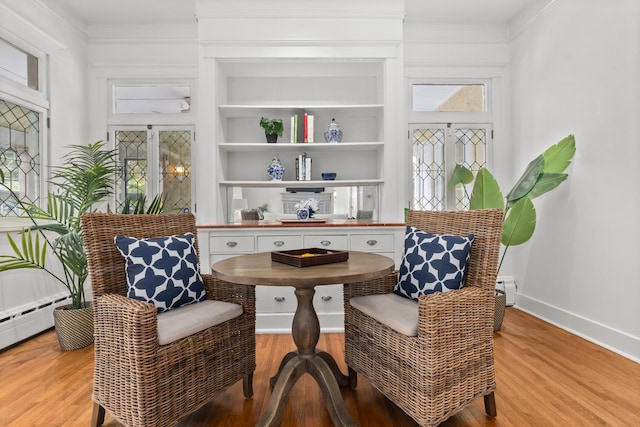 714 Sheridan Rd, Evanston, IL 60202 - living area featuring light wood-type flooring, baseboards, baseboard heating, and built in shelves