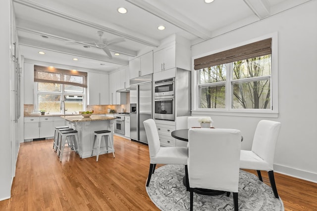 714 Sheridan Rd, Evanston, IL 60202 - dining room featuring beam ceiling, recessed lighting, light wood finished floors, baseboards, and a ceiling fan