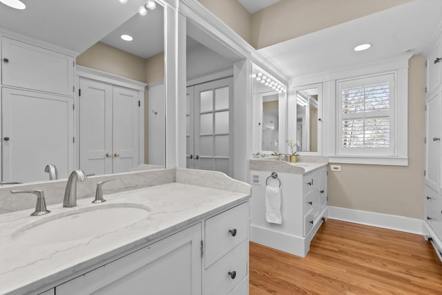 714 Sheridan Rd, Evanston, IL 60202 - bathroom with baseboards, vanity, wood finished floors, and recessed lighting