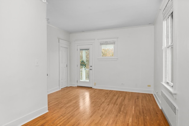 714 Sheridan Rd, Evanston, IL 60202 - empty room with ornamental molding, baseboards, and light wood-style flooring