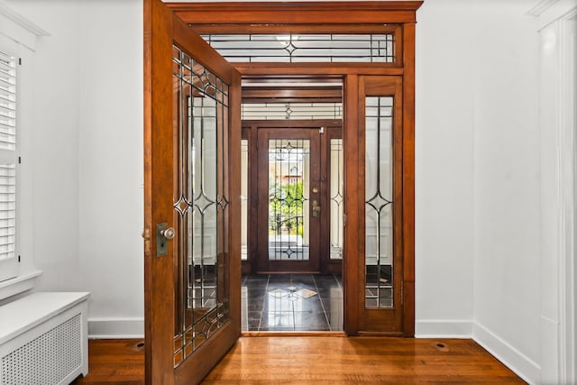 714 Sheridan Rd, Evanston, IL 60202 - foyer featuring baseboards, radiator heating unit, and wood finished floors