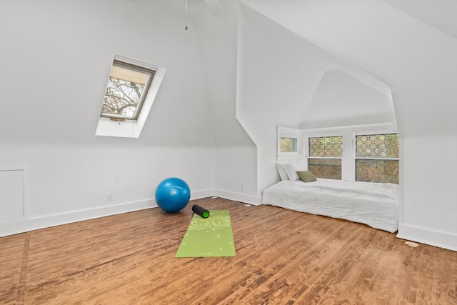 714 Sheridan Rd, Evanston, IL 60202 - exercise area featuring a skylight, baseboards, wood finished floors, and lofted ceiling