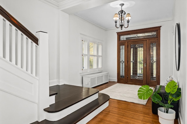 714 Sheridan Rd, Evanston, IL 60202 - foyer entrance featuring radiator, stairway, a chandelier, wood finished floors, and ornamental molding