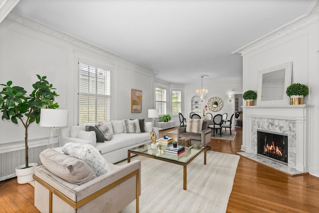 714 Sheridan Rd, Evanston, IL 60202 - living room featuring a chandelier, crown molding, wood finished floors, and a high end fireplace