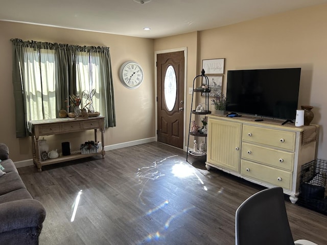 foyer featuring baseboards and wood finished floors