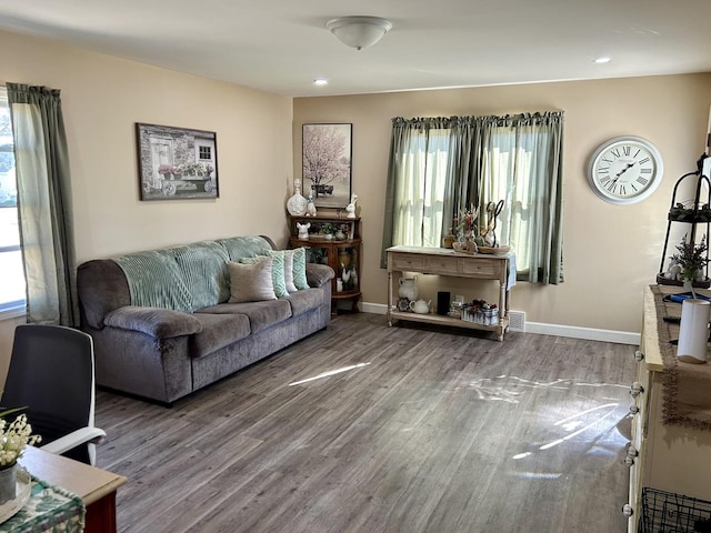 living room with baseboards, wood finished floors, and recessed lighting