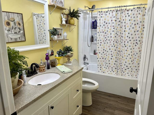 full bath featuring vanity, wood finished floors, shower / bath combo with shower curtain, and toilet