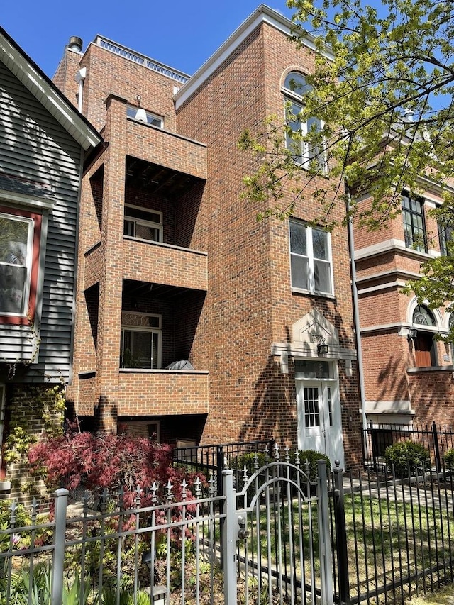 view of building exterior with a fenced front yard